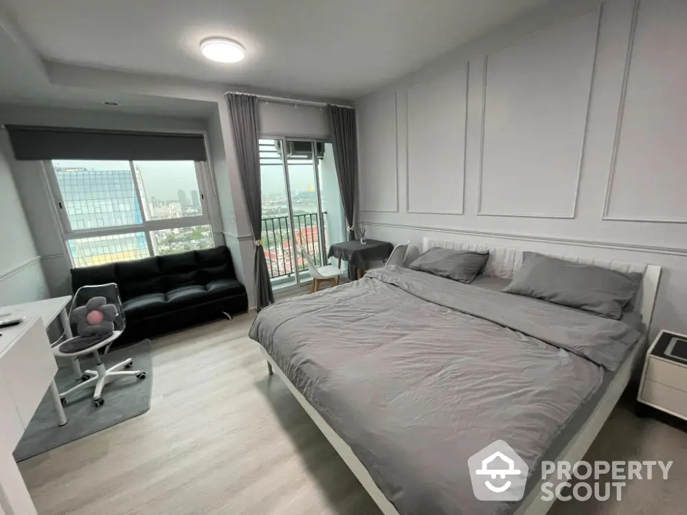 Modern bedroom with city view and balcony access, featuring stylish decor and comfortable furnishings.