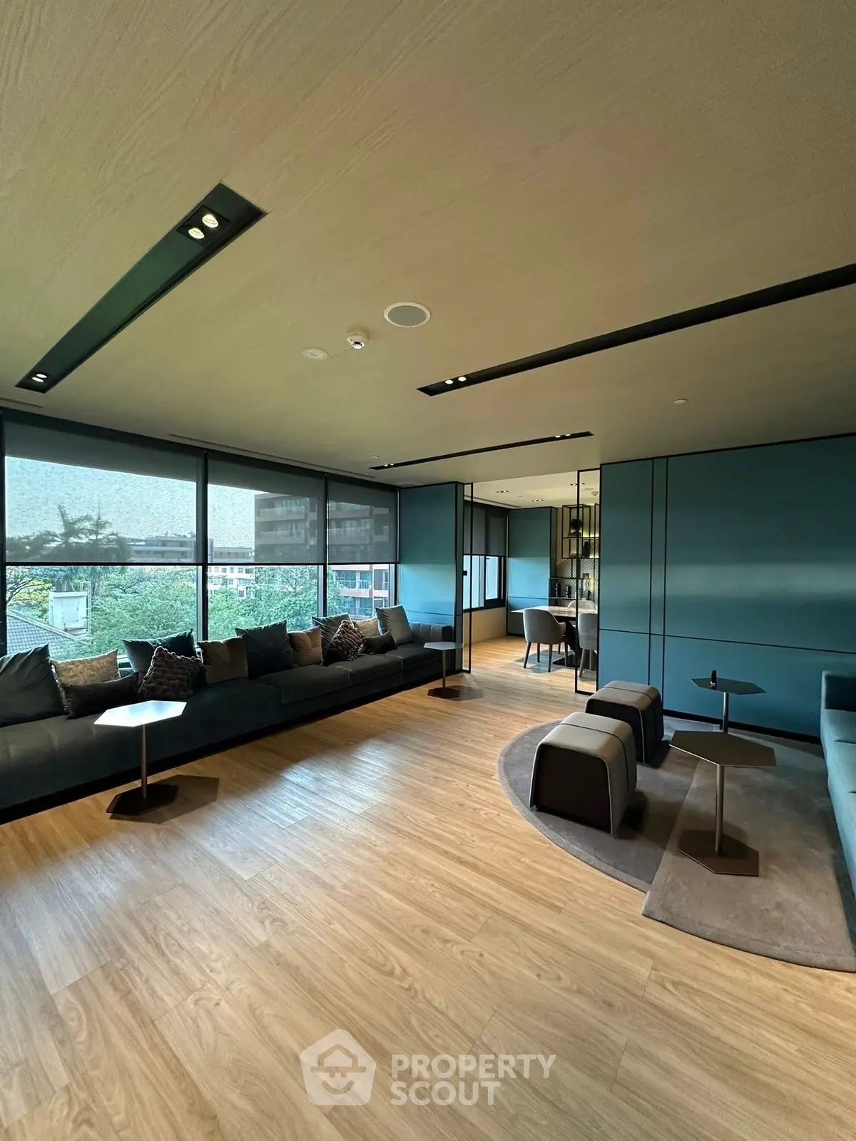 Spacious modern living room with large windows and elegant seating area