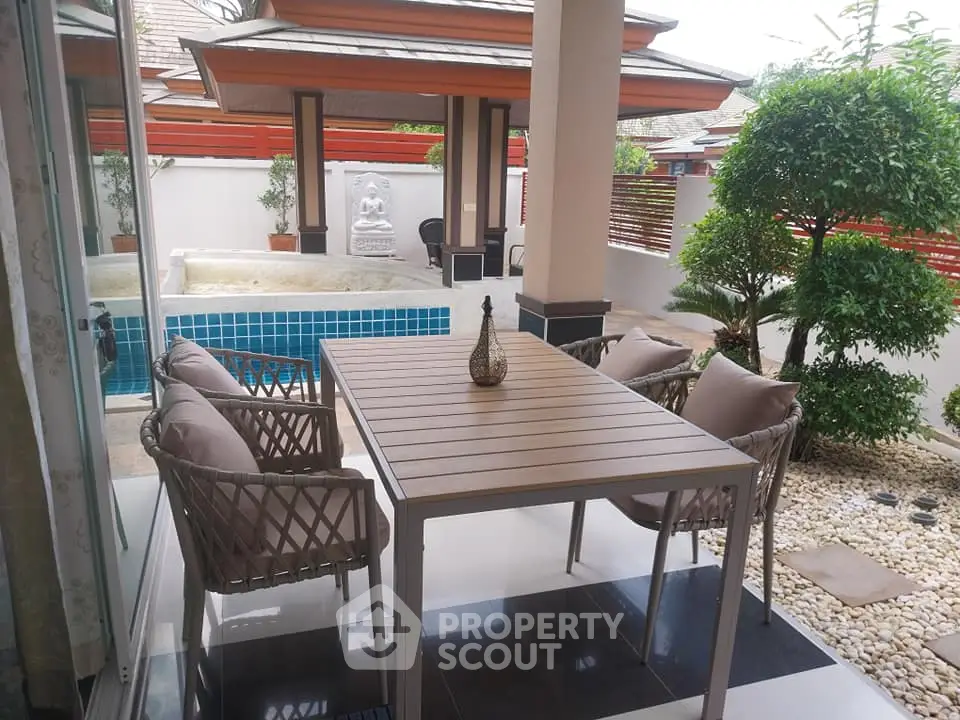 Luxurious patio with pool view and stylish outdoor furniture in serene setting