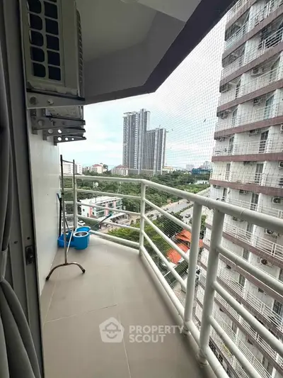 Spacious balcony with city view in modern high-rise apartment