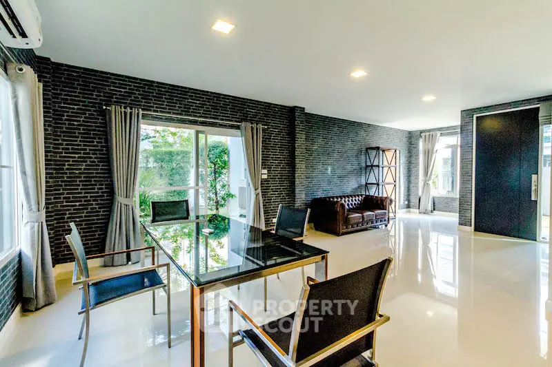 Spacious modern living room with sleek design and large windows offering natural light.