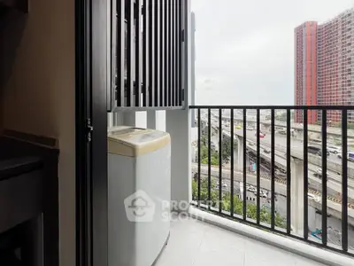 Modern balcony with washing machine and city view, ideal for urban living.