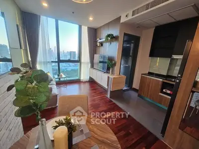 Luxurious high-rise apartment with stunning city view and modern open kitchen layout.