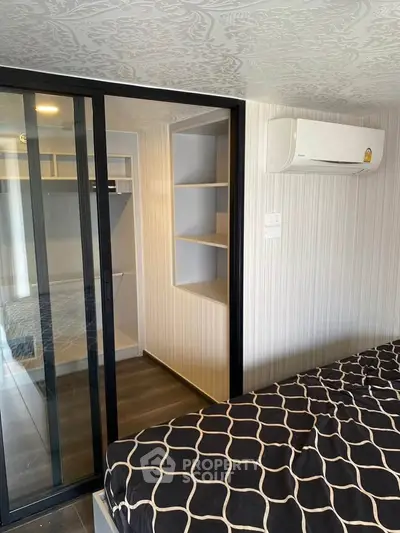 Modern bedroom with sliding glass door and air conditioning unit