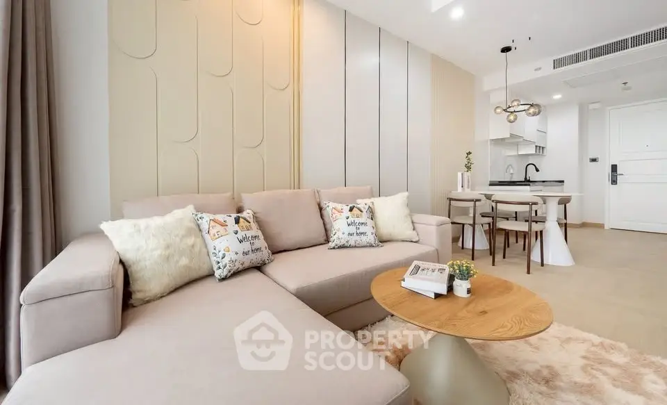 Modern living room with cozy beige sofa and stylish open kitchen layout
