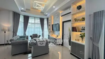 Luxurious modern living room with elegant decor and large windows.