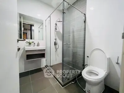 Modern bathroom with glass shower enclosure and sleek fixtures