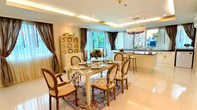 Luxurious dining room with elegant decor and large windows in a modern apartment.