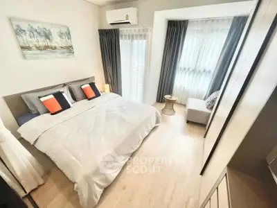 Modern bedroom with large windows and stylish decor in a cozy apartment.