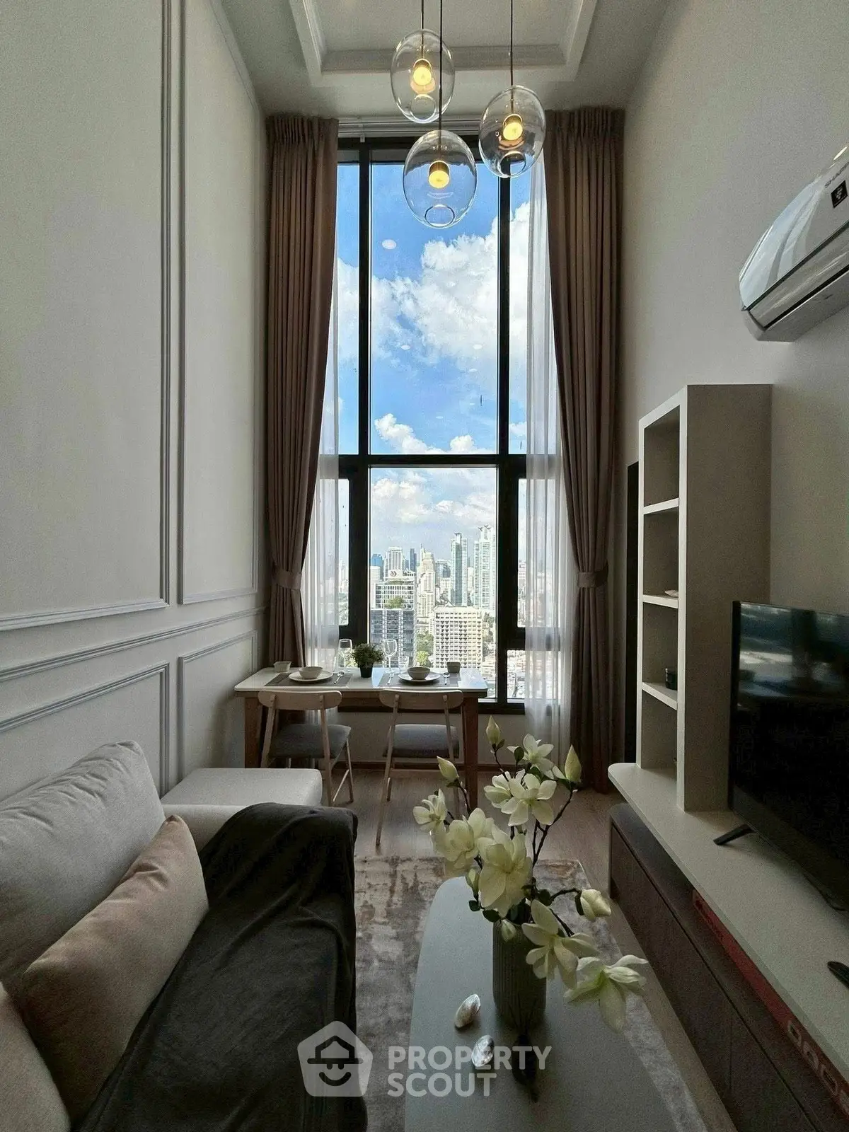 Luxurious high-rise living room with stunning city view and modern decor.