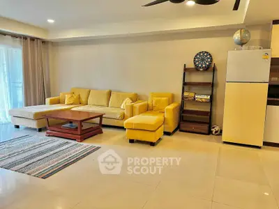 Spacious living room with yellow sofa, modern decor, and ample natural light.