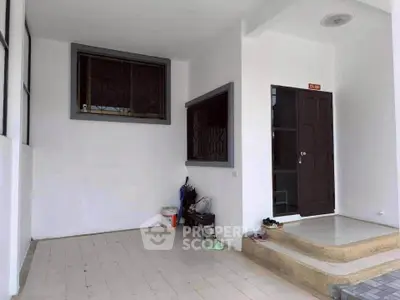 Charming entrance with tiled flooring and secure windows in a cozy residential property.