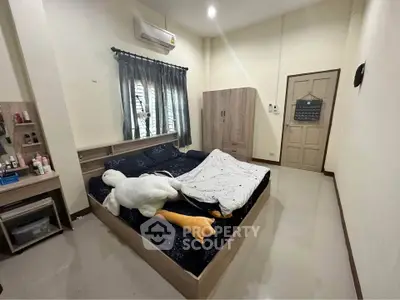 Cozy bedroom with modern furnishings and plush decor in a stylish apartment.