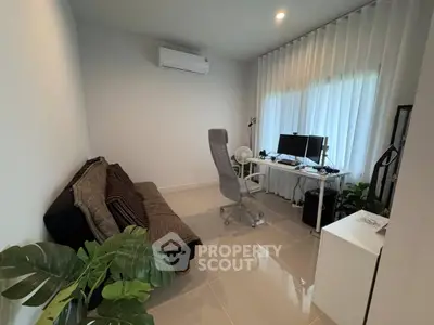 Modern home office with sleek desk, ergonomic chair, and cozy sofa in a bright room with large windows.