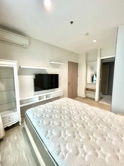 Modern bedroom with wall-mounted TV and stylish decor
