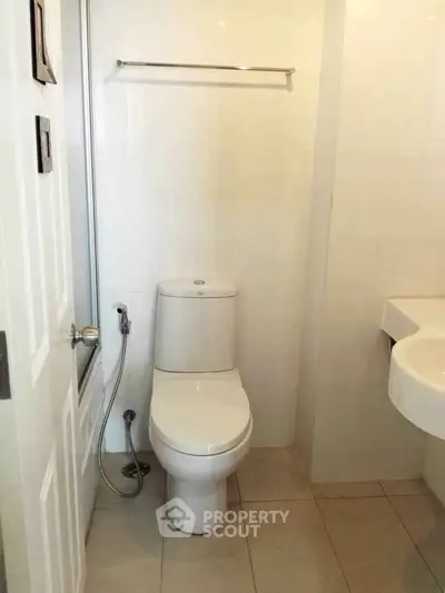 Compact bathroom with modern fixtures and neutral tiles