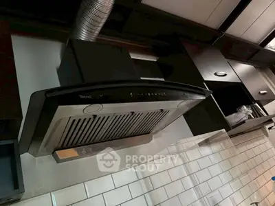 Modern kitchen with sleek range hood and subway tile backsplash