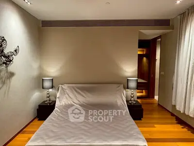 Luxurious bedroom with elegant lighting and wooden flooring