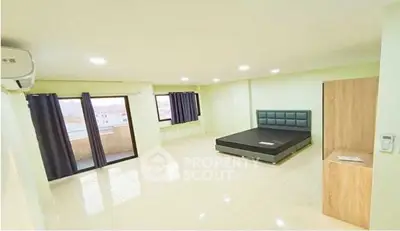 Spacious bedroom with modern design and large windows for natural light