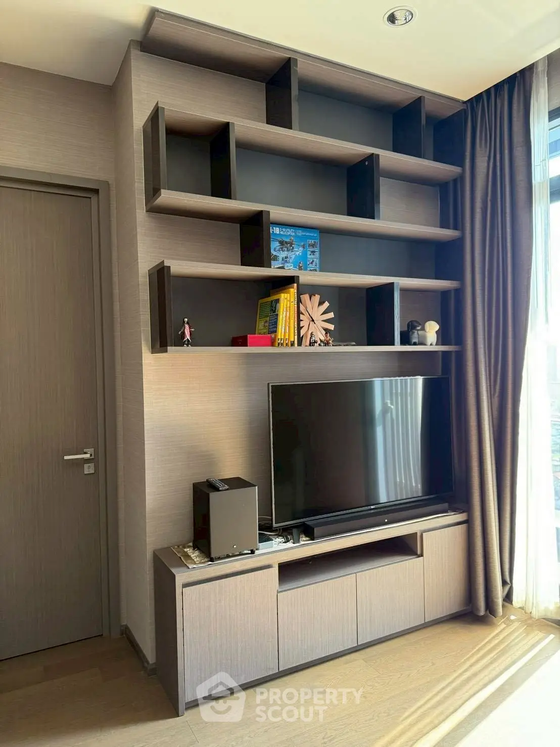 Modern living room with sleek entertainment center and natural light