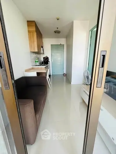 Modern compact apartment with sliding doors and sleek furnishings