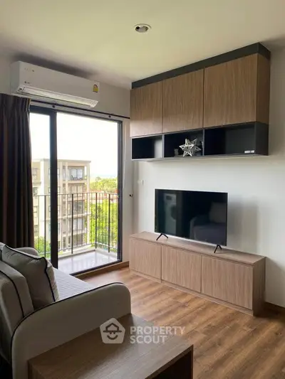 Modern living room with balcony view, sleek furniture, and natural light in a stylish apartment.