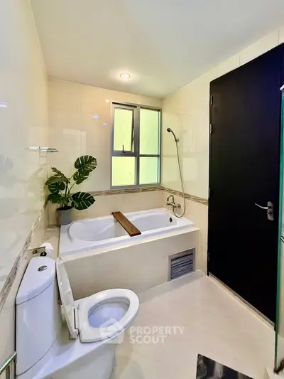 Modern bathroom with bathtub and sleek design, perfect for relaxation.