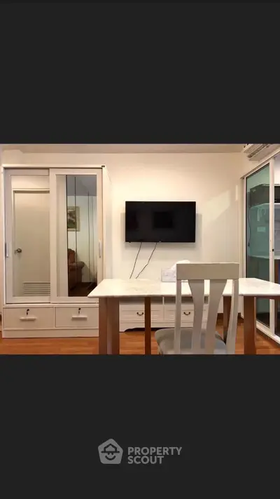 Modern interior with sleek furniture and wall-mounted TV in a stylish living space.