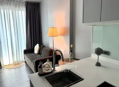 Modern living room with cozy sofa and stylish lighting in a contemporary apartment.