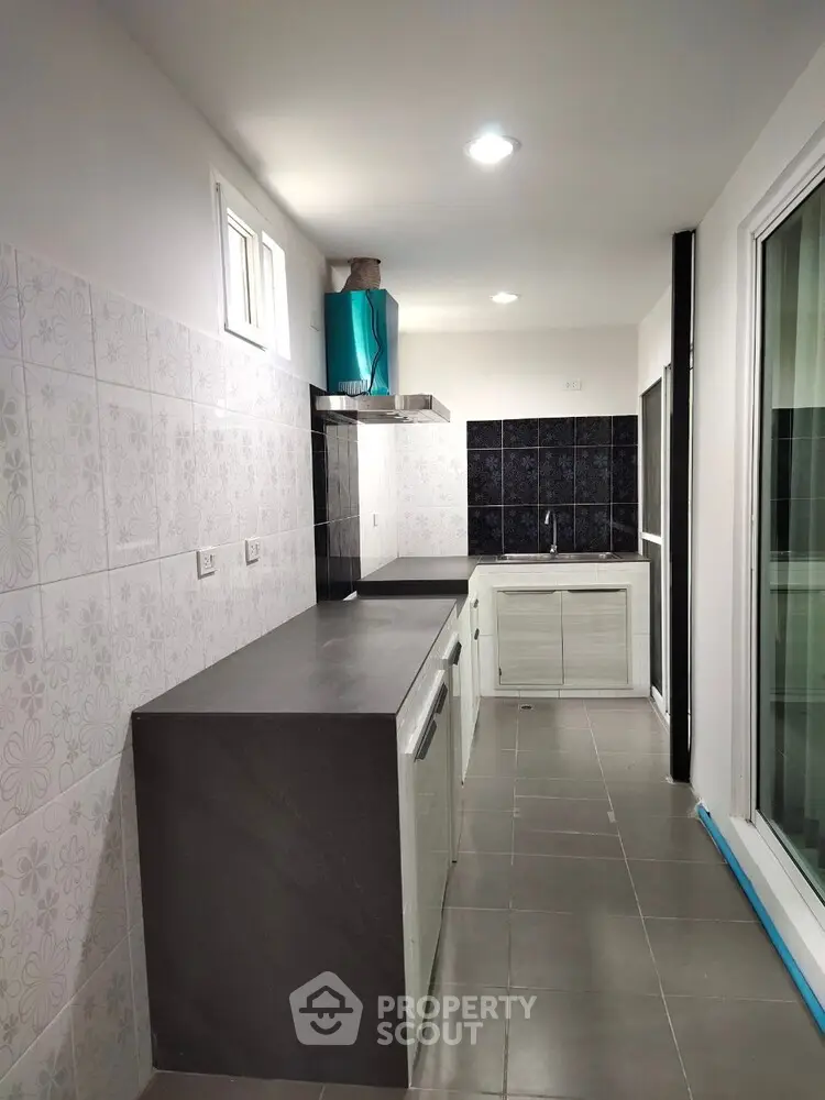 Modern kitchen with sleek countertops and stylish backsplash