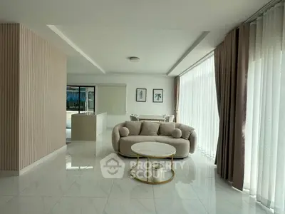 Spacious modern living room with elegant decor and large windows