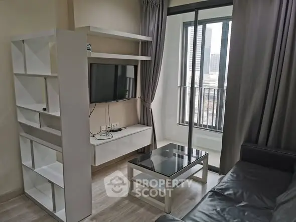 Modern living room with sleek furniture and city view balcony