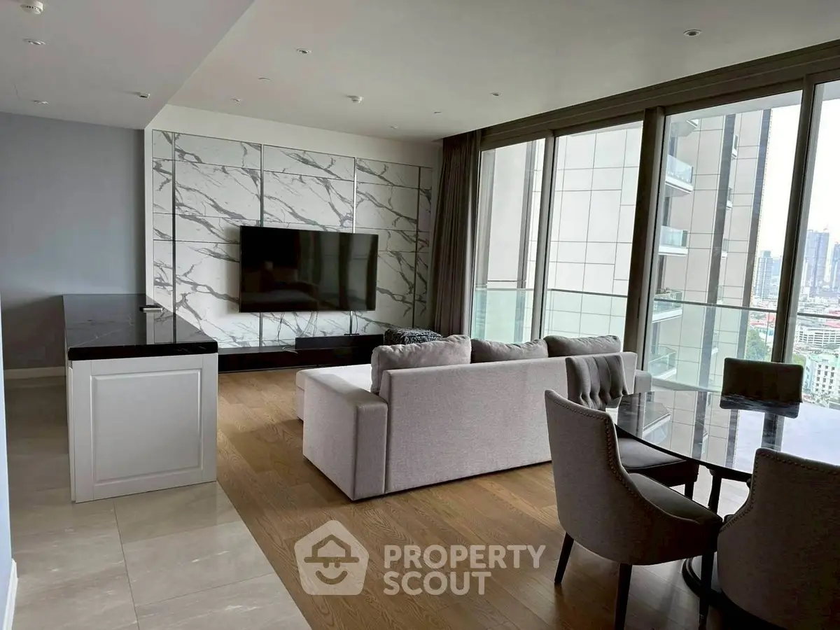 Luxurious living room with city view, modern furniture, and elegant marble wall design.