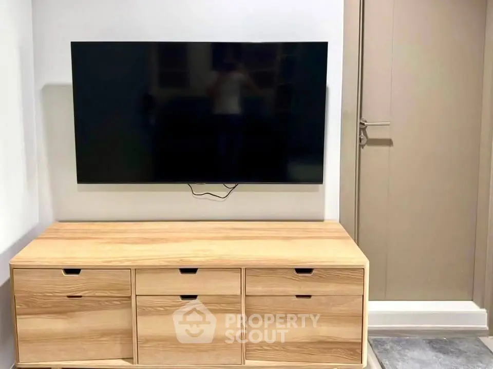 Modern living room with sleek TV setup and stylish wooden cabinet