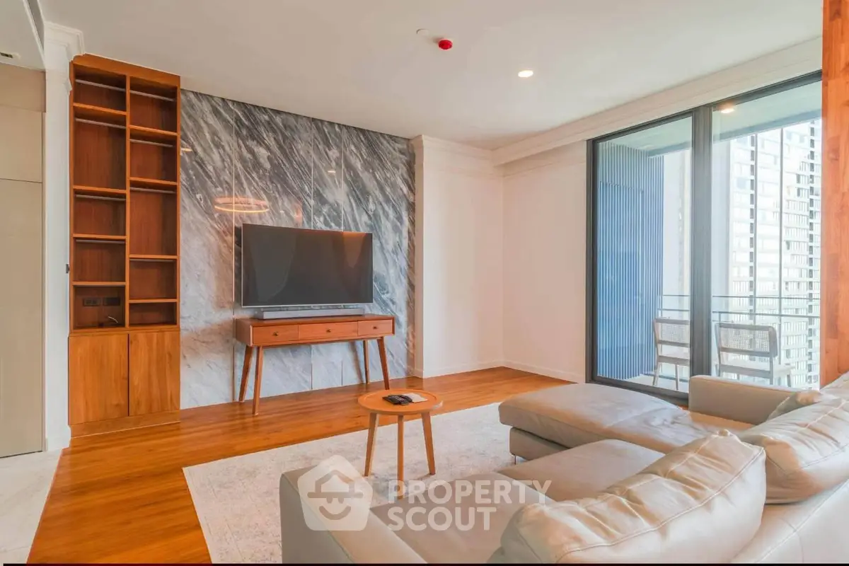 Modern living room with stylish decor and large windows offering city views.