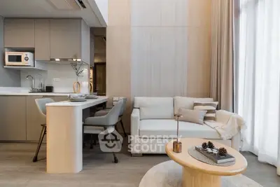 Modern open-plan living room with cozy seating and stylish kitchen area