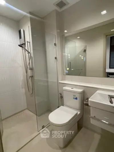 Modern bathroom with glass shower and sleek fixtures