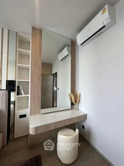 Modern bedroom with stylish vanity and air conditioning unit