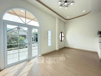 Bright and spacious room with modern lighting and large windows