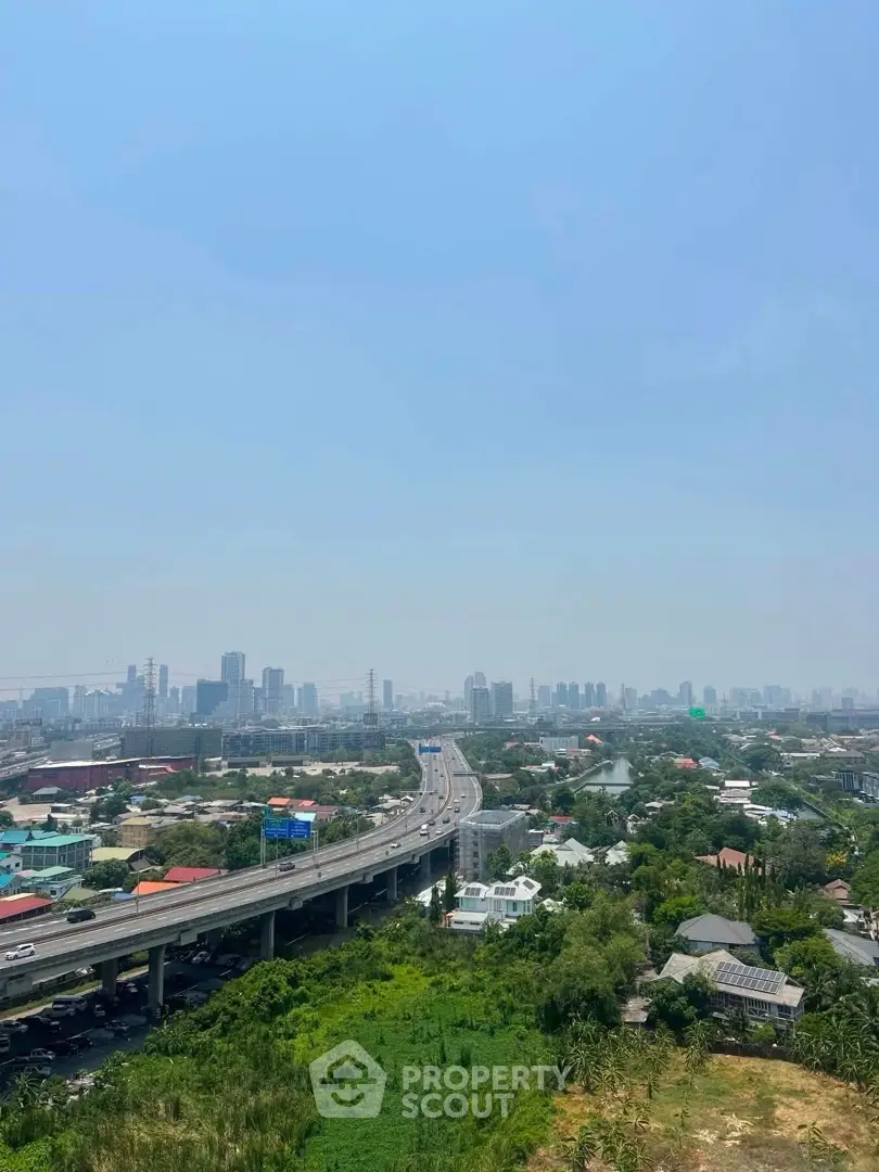 Stunning cityscape view with highway and lush greenery, perfect for urban living enthusiasts.