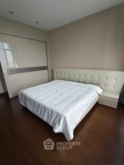 Spacious bedroom with modern design and elegant furnishings in a luxury apartment.