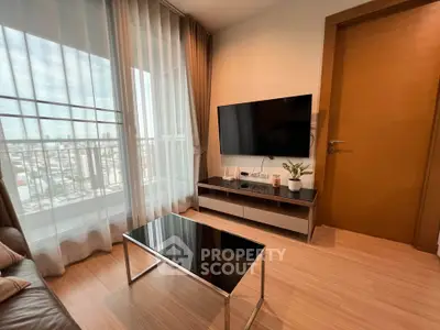 Modern living room with sleek TV setup and city view from large window.