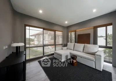 Modern living room with large windows and stylish furniture in a contemporary home.