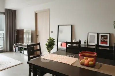 Modern dining area with sleek furniture and natural light, perfect for urban living.