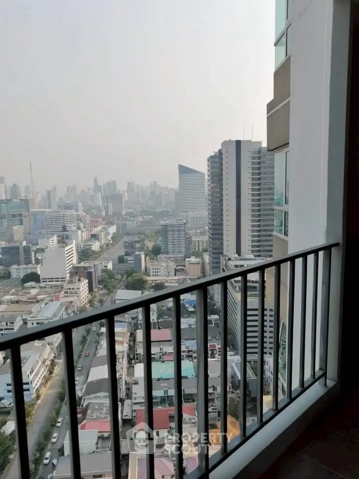 Stunning cityscape view from high-rise balcony overlooking urban skyline.