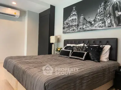 Luxurious bedroom with elegant decor and stylish black-and-white cityscape artwork.