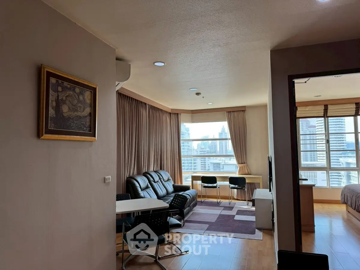 Spacious living room with city view and modern furnishings