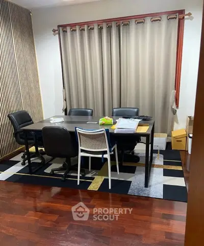 Modern study room with elegant wooden flooring and stylish furniture, perfect for productivity and comfort.