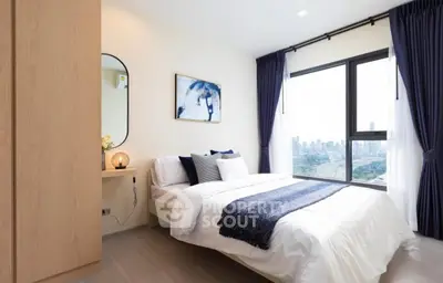 Modern bedroom with city view, elegant decor, and natural light.