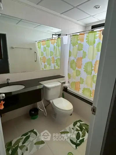 Modern bathroom with stylish decor and vibrant shower curtain